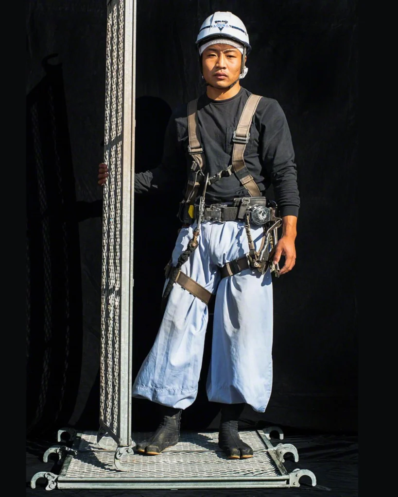 Tobi worker in traditional Japanese workwear, featuring loose-fitting trousers (tobi pants) and a jacket, showcasing the unique and functional style of Japanese construction fashion.